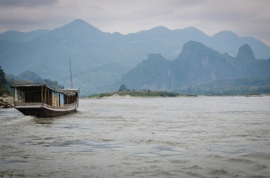 Amantaka - Boat on Mekong with Mountains